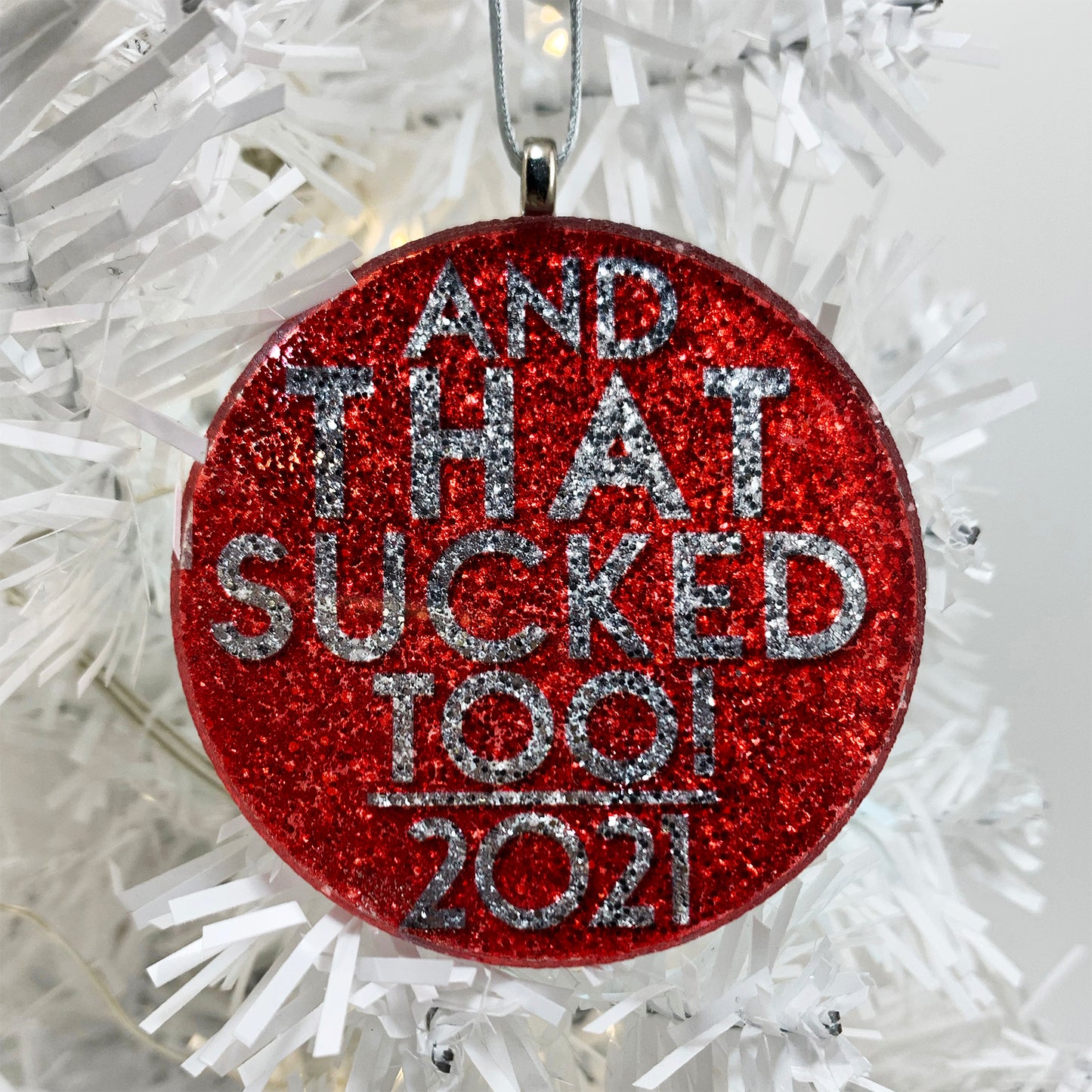 "And THAT Sucked Too!" Ornament for 2021 - round silver glitter ornament, text on red background - 1 of 3 handmade glass and glitter ornaments in our 2021 Ornament Trio
