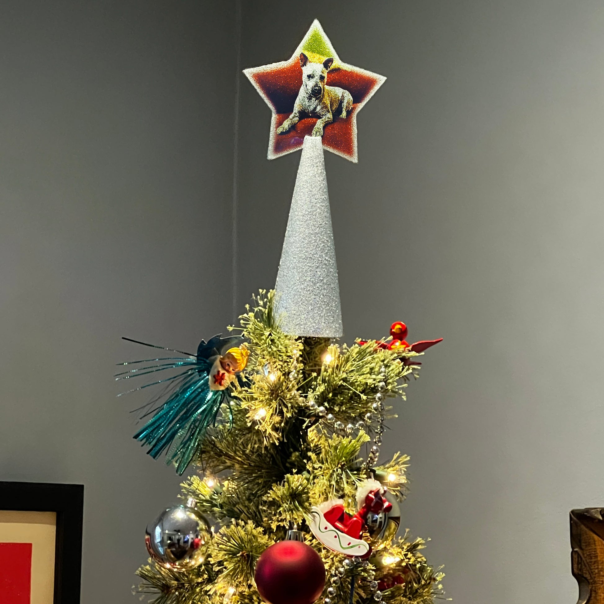 customer-submitted photo of silver custom tree topper with white dog, on decorated Christmas tree