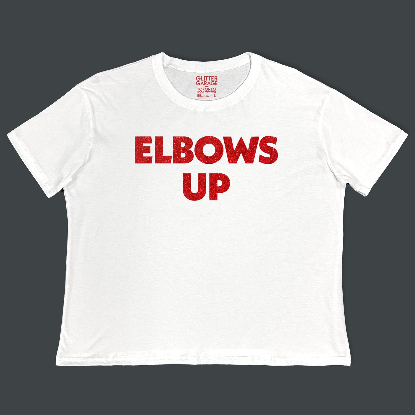 "Elbows Up" large text in red glitter on white Canadian-made boxy tee