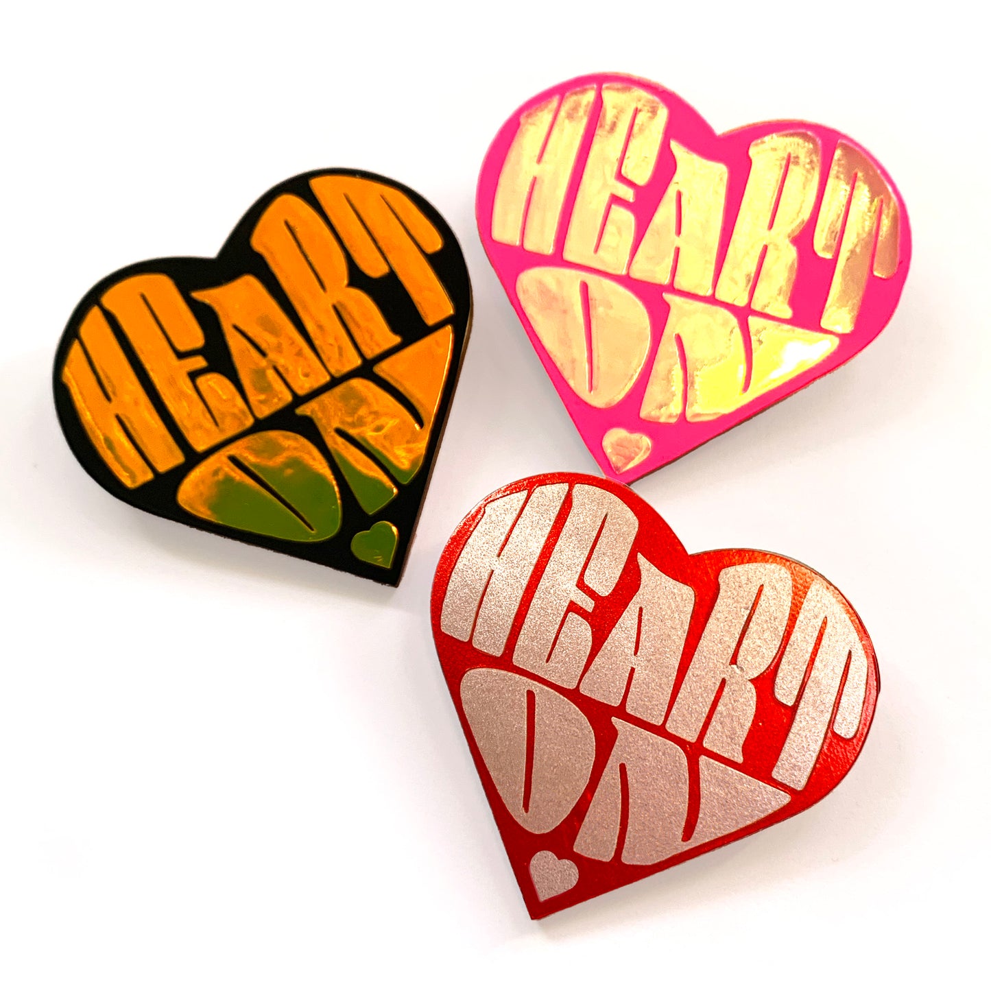 3 "Heart On" heart-shaped wood and vinyl pins - colour options holo tropical gold on matte black, holo pearl on neon pink, metallic rose gold pink on metallic red