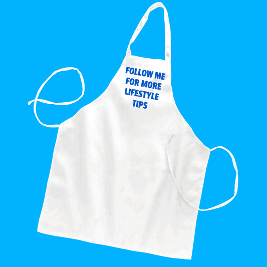 White butcher-style apron with custom text "follow me for more lifestyle tips" in neon blue