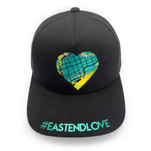 Load image into Gallery viewer, Black snapback hat with #EastEndLove + heart-shaped map in metallic teal, opalescent vinyl
