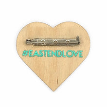Load image into Gallery viewer, #EastEndLove handmade pin, metallic teal east-end-map heart on wood base - back with teal #EastEndLove text and secure locking bar pin
