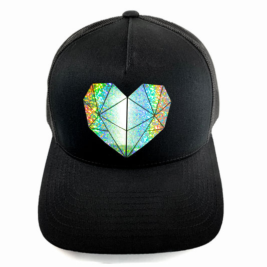 Classic black snapback hat with holographic faceted heart detail by BBJ / Glitter Garage. Unisex style, breathable mesh back with matching plastic snap closure fits most. Front view.