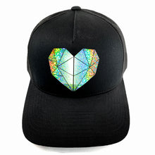 Load image into Gallery viewer, Classic black snapback hat with holographic faceted heart detail by BBJ / Glitter Garage. Unisex style, breathable mesh back with matching plastic snap closure fits most. Front view.
