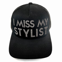 Load image into Gallery viewer, Classic black snapback hat with bold I Miss My Stylist text by BBJ / Glitter Garage. Silver glitter text. Front view.
