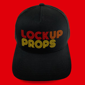 Lock Up Props red, orange, yellow retro type logo on black unisex trucker cap by BBJ / Glitter Garage