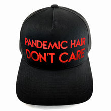 Load image into Gallery viewer, Classic black snapback hat with bold Pandemic Hair Don&#39;t Care red metallic text by BBJ / Glitter Garage. Glitter and matte vinyl colour options. Unisex style, breathable mesh back with matching plastic snap closure fits most.
