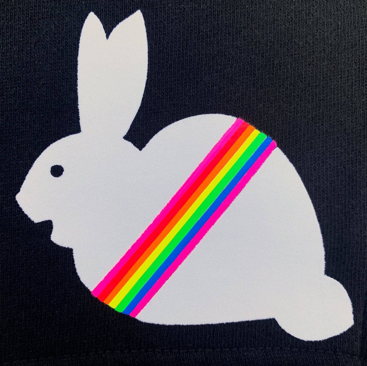 texture detail of fuzzy white flock bunny with neon rainbow stripe on black unisex shorts by BBJ / Glitter Garage